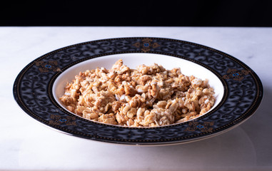 Cereal In A China Cup On A Saucer On Marble With Black Background
