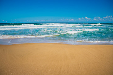 Fototapeta na wymiar Sandy beach and blue ocean