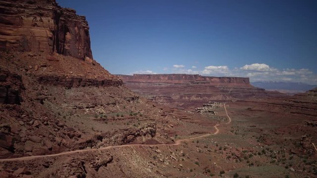 Mountain road among the landscape of red erosion rocks  in Canyonlands National Park, Utha