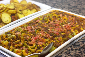 Vegetable stew with red beans on a white dish in a restaurant