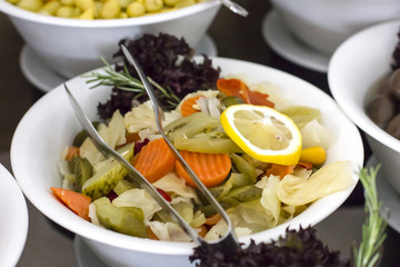 Sliced marinated vegetables in a white bowl