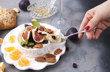 Cheese with white mold and figs, honey and nuts. Autumn sweets and fruits and wine. Delicious food for dinner. Top view