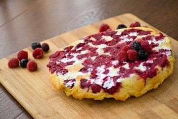 Cheesecake with raspberries and blackberry close-up. Light breakfast.