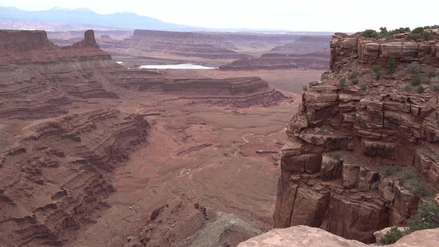 Mountain landscape of red erosion rocks and salt lake in Canyonlands National Park, Utha