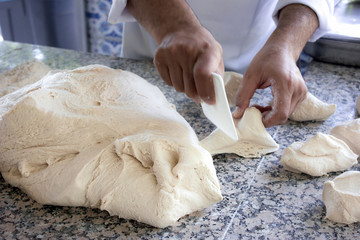 Chef cook works with a yeast dough