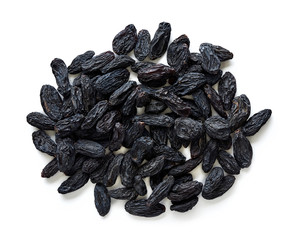 Heap of black raisins isolated on white background. Top view of dried grapes.