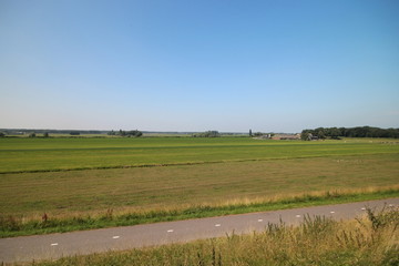 Obraz premium Fields, roads,bicycle lanes and canals along the dyke of the Hollandsche IJssel in Moordrecht, the Netherlands/