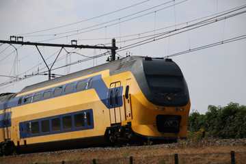 Obraz premium Double decker intercity train on the track at Moordrecht heading to Gouda in the Netherlands.