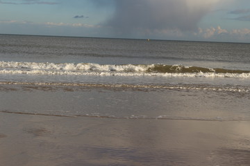 Waves crashing on a white sand beach