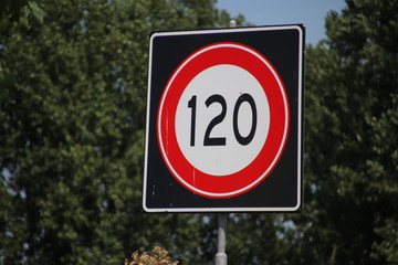 Speed sign along the motorway in the Netherlands with speed limit of 120 kilometers .