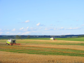 Fototapeta na wymiar Two combines harvester00000 working in a very wide field
