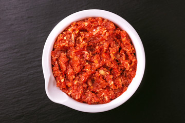 Traditional Maghrebi hot chili pepper sauce paste harissa. adjika
