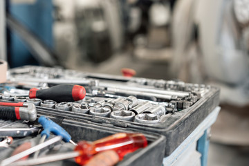 Dirty set of hand tools and wrenchs close-up in box. Garage painting car service. Tool to repair the car or replace automotive spare parts, auto parts. Dirty tool service