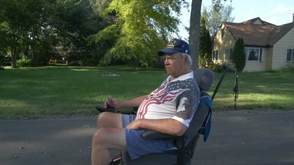 A disabled war veteran in a powered wheelchair