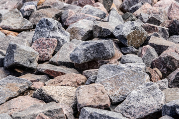 a mass of different sizes of stones of gray and blue color. texture