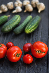 Tomatoes, cucumbers and garlic on the table. Harvest from the garden