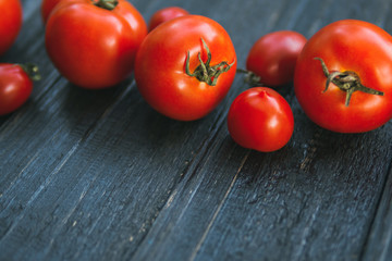 Ripe red tomatoes on a wooden table with copy space
