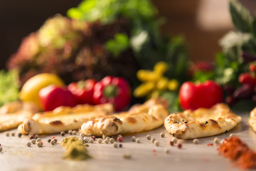 Adana Pide and tomato, lemon, lettuce,pepper and green vegetables on the wooden background for restaurant and cafe concept.