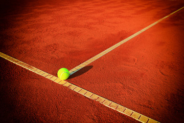 Tennis balls on a tennis clay court