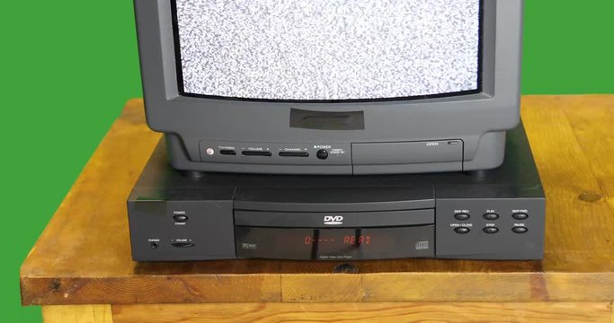 Vintage TV and DVD player on green screen with sound