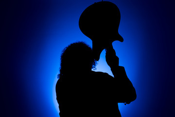 Shadow of a musician destroying a guitar
