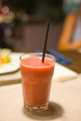 orange and raspberry smoothie on the dinner table