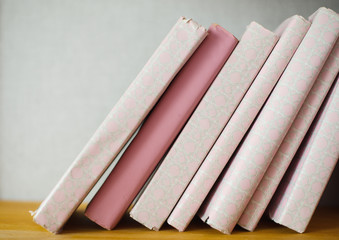 shabby white and pink book covers on the shelf