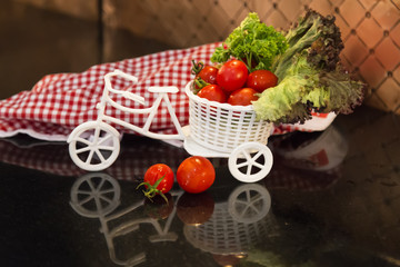 organic vegetables,white car and red and white service napkin on the wooden background.tomatoes,lettuce on the car for restaurant and cafe concept.