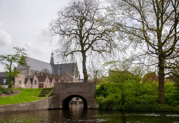 Fototapeta na wymiar Church with River and Canal in Holland, The Netherlands