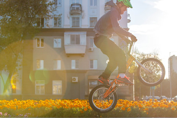 BMX rider in helmet training on street 
