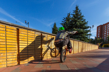 BMX cyclist made tricks on street, pro rider trainong