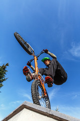 BMX cyclist made tricks on street, pro rider trainong