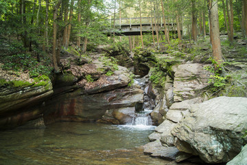 Naklejka na ściany i meble Waterfall Cutting Through Bedrock Of Mountain Side In Pennsylvania