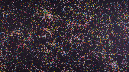 Black background with colorful sprinkles all over