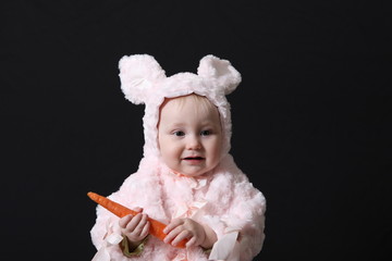 Portrait of the baby holding vegetables 