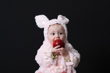 Portrait of the baby holding vegetables 