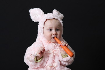 Portrait of the baby holding vegetables 