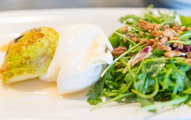 Classic salad with pear, arugula or rocket leaves, shaved parmesan, and walnuts. Drizzled with olive oil. lemon vinegar, burrata,spiced,macadamia.