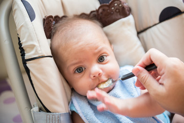 Baby blue eyed boy eating baby baby - In baby stroller