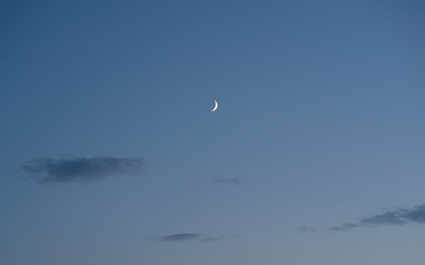 Twilight clear blue sky with perfect crescent moon for background