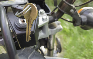 Ignition key in a motorcycle standing on a trail