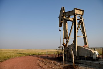 Crude oil pump jack operating in the rural fields of the Powder River Basin in Northeast Wyoming