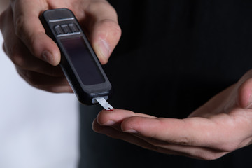 blood sugar test strip has absorbed the blood and the meter is providing an accurate reading