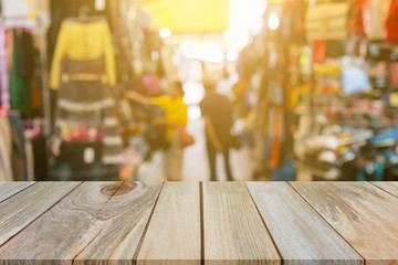 Wood table top on blur with bokeh second hand market background - can be used for display or montage your products.