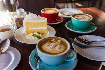 coffee time in the wood table cafe , drink coffee and tasty cake