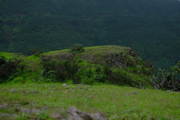 Lush green monsoon nature landscape mountains, hills, farming plot, Purandar, Pune, Maharashtra, India 