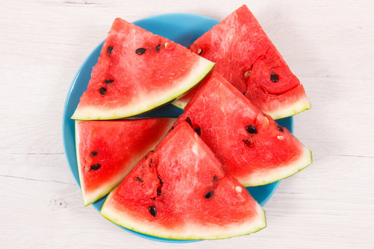 Slice of watermelon on blue plate, concept of healthy delicious dessert