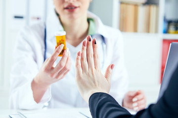 Female patient at the doctor appointment refuses to take prescribed medications, believes that they...