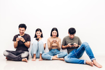 Group of friend sitting relax use technology together of smartphone checking social apps against copy space background.Communication concept