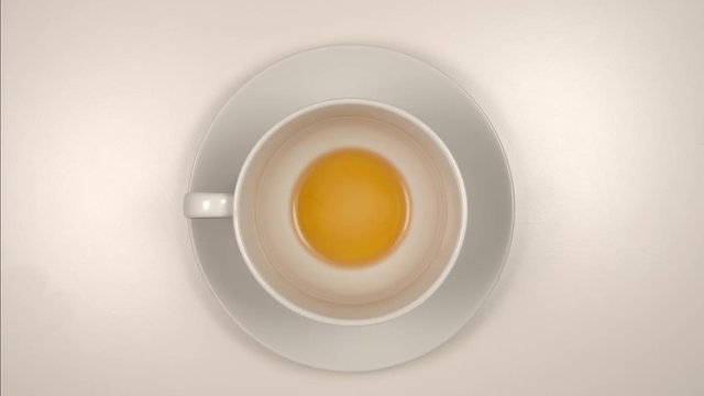 TOP VIEW: Drinking a black tea from a white teacup on a table - Stop motion